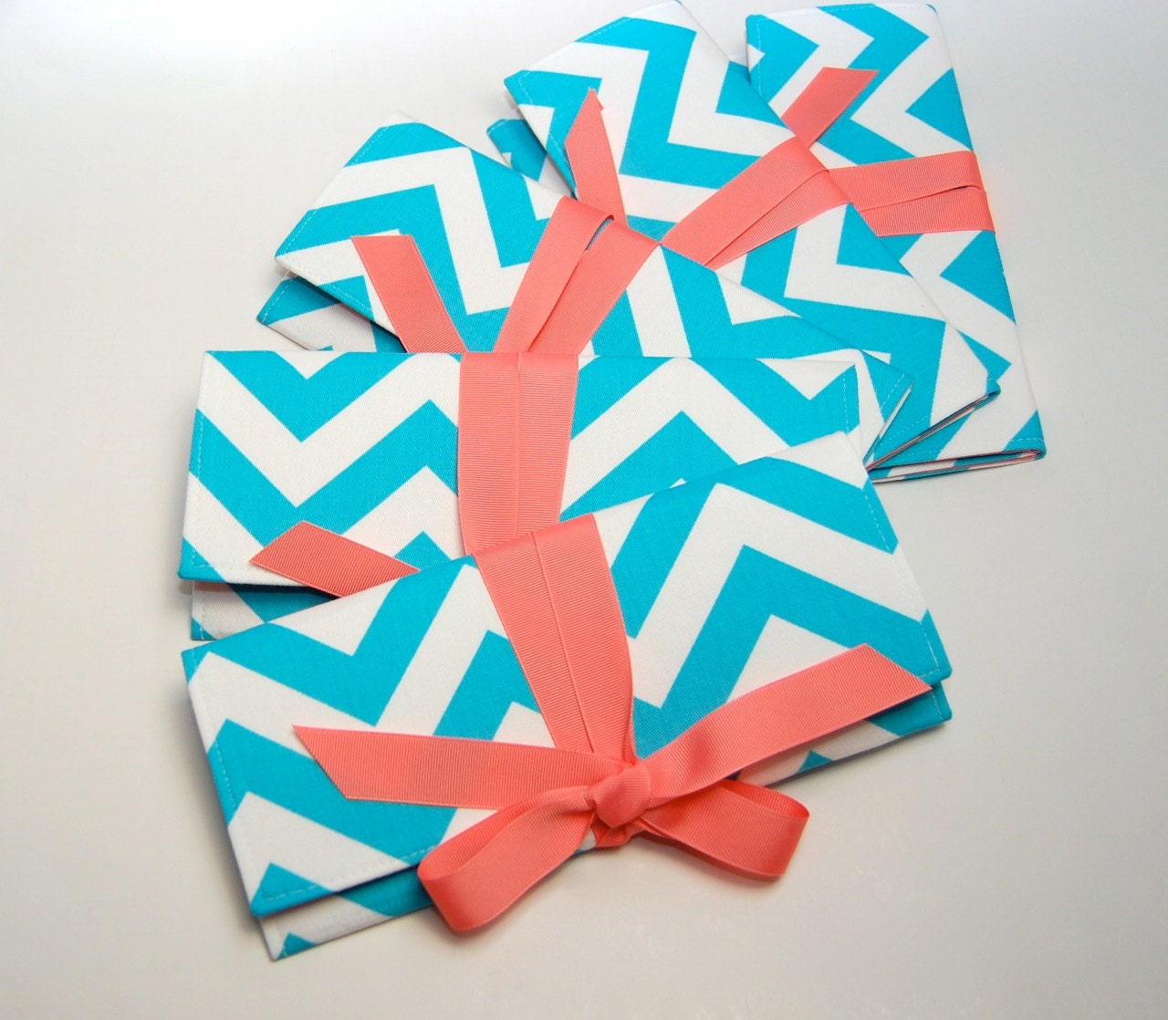 Chevron bridesmaid clutches in aqua blue and coral. Custom colors available.