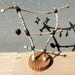 Twig ladder for earring display with round wooden base..a functional sculpture for earrings..reclaimed wood