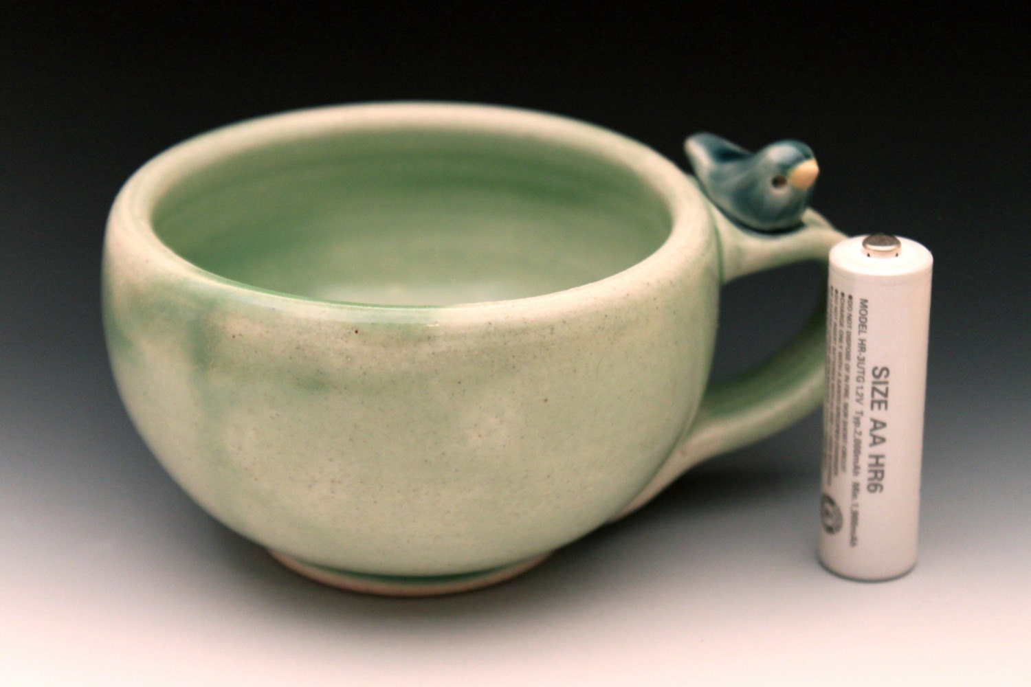 Sweet Little Blue Bird on a Pale Green Cup