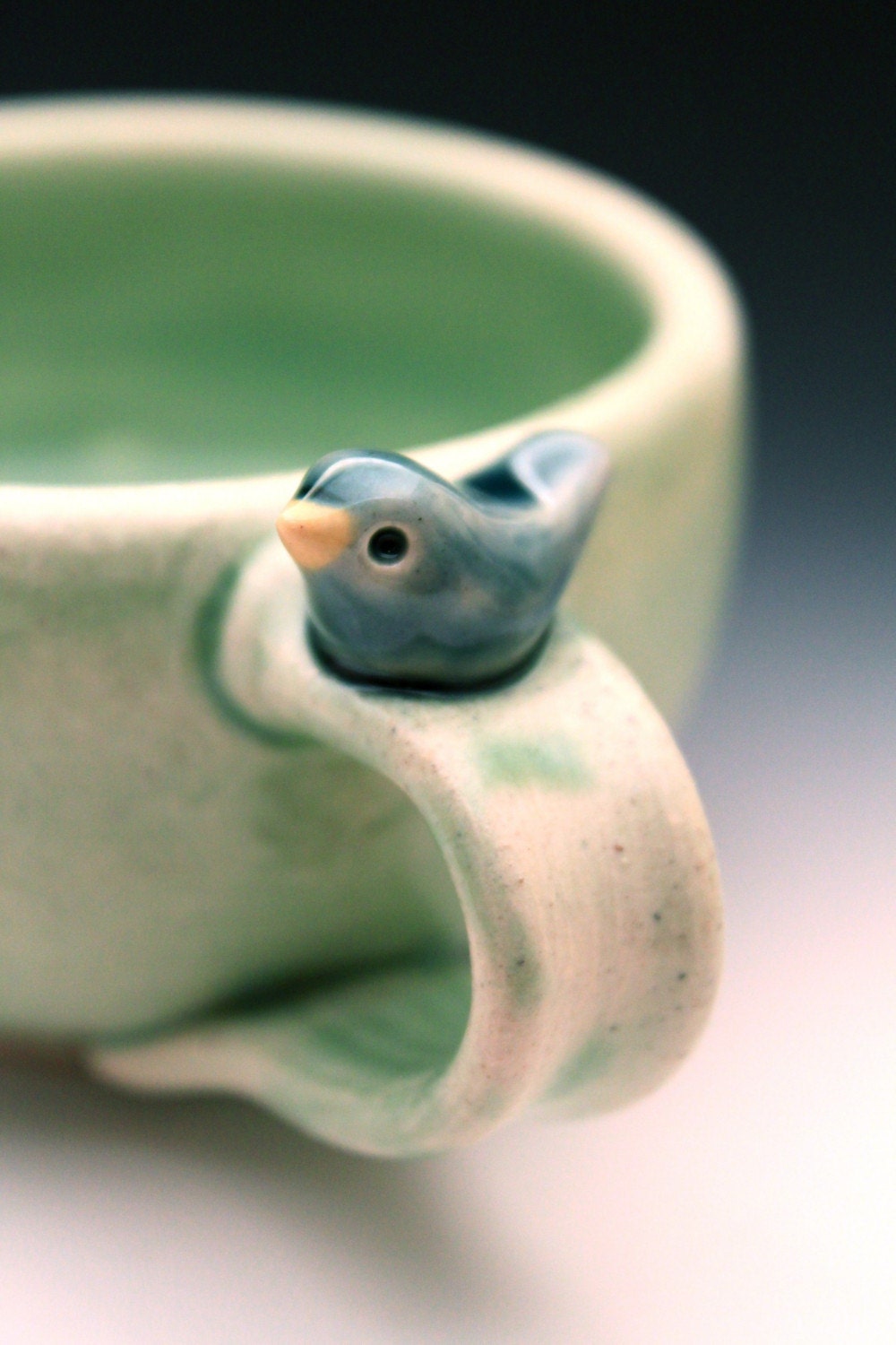 Sweet Little Blue Bird on a Pale Green Cup
