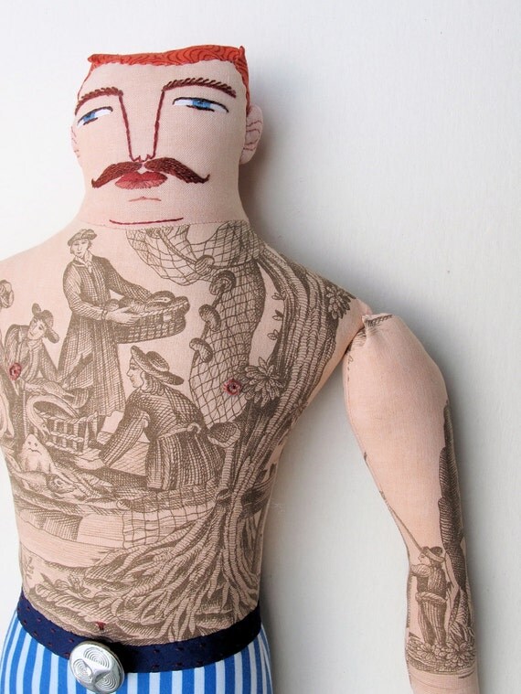 red-haired man with boat tattoo
