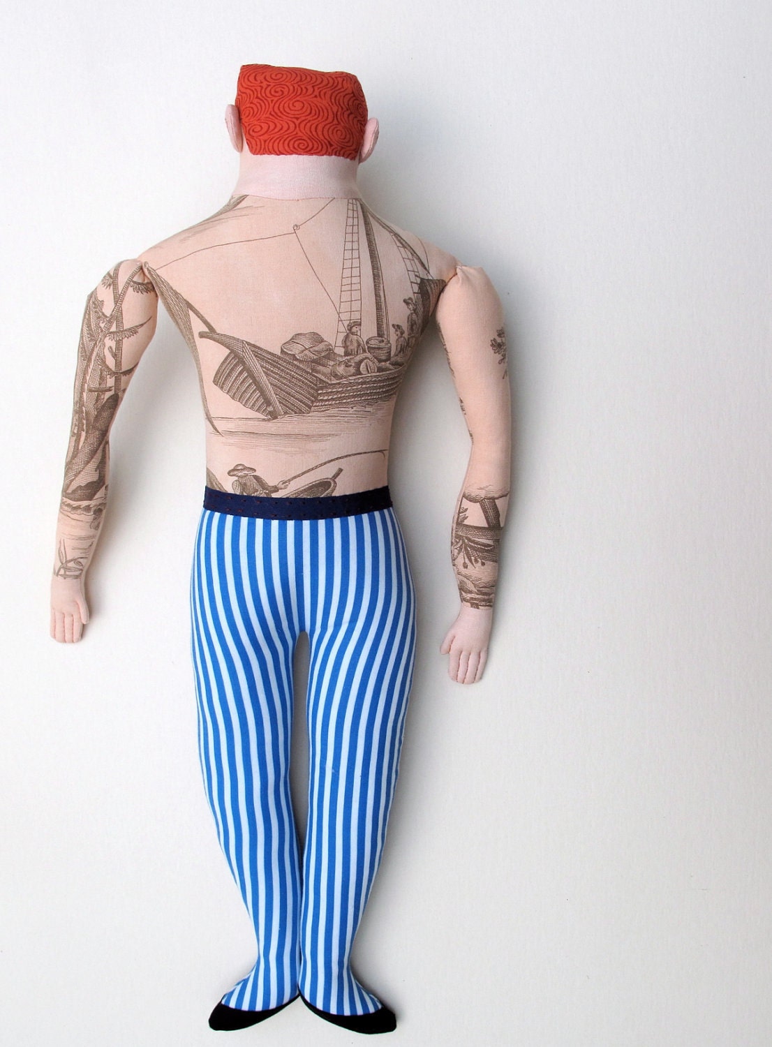 red-haired man with boat tattoo
