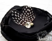 Handmade flower in black with spotted feathers, fresh water pearl and Swarovski crystals.