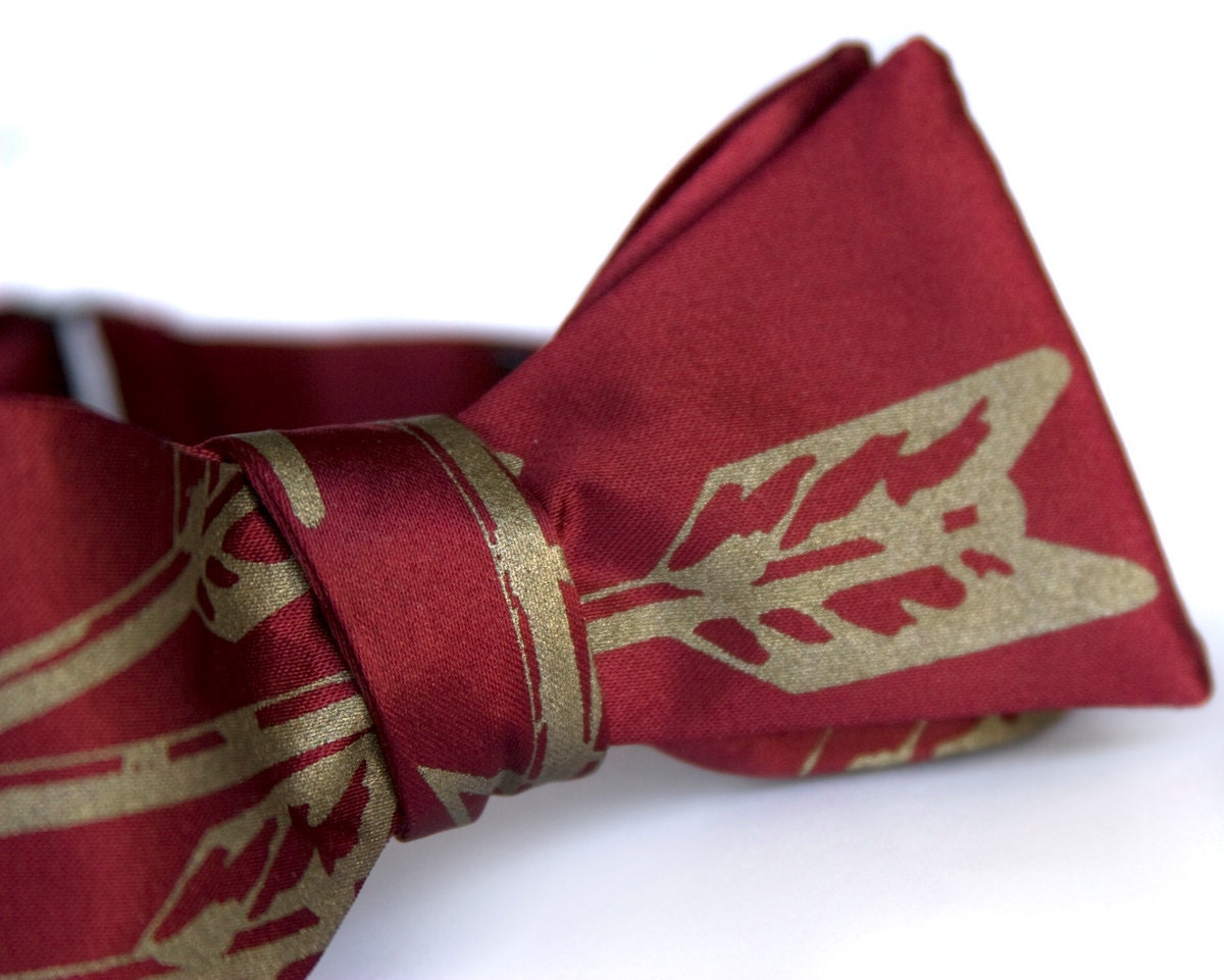 Burgundy Arrows bow tie, freestyle. Silkscreened necktie, antique brass print. "Quiver."