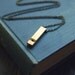 whistle statement necklace in brass on long minimal chain