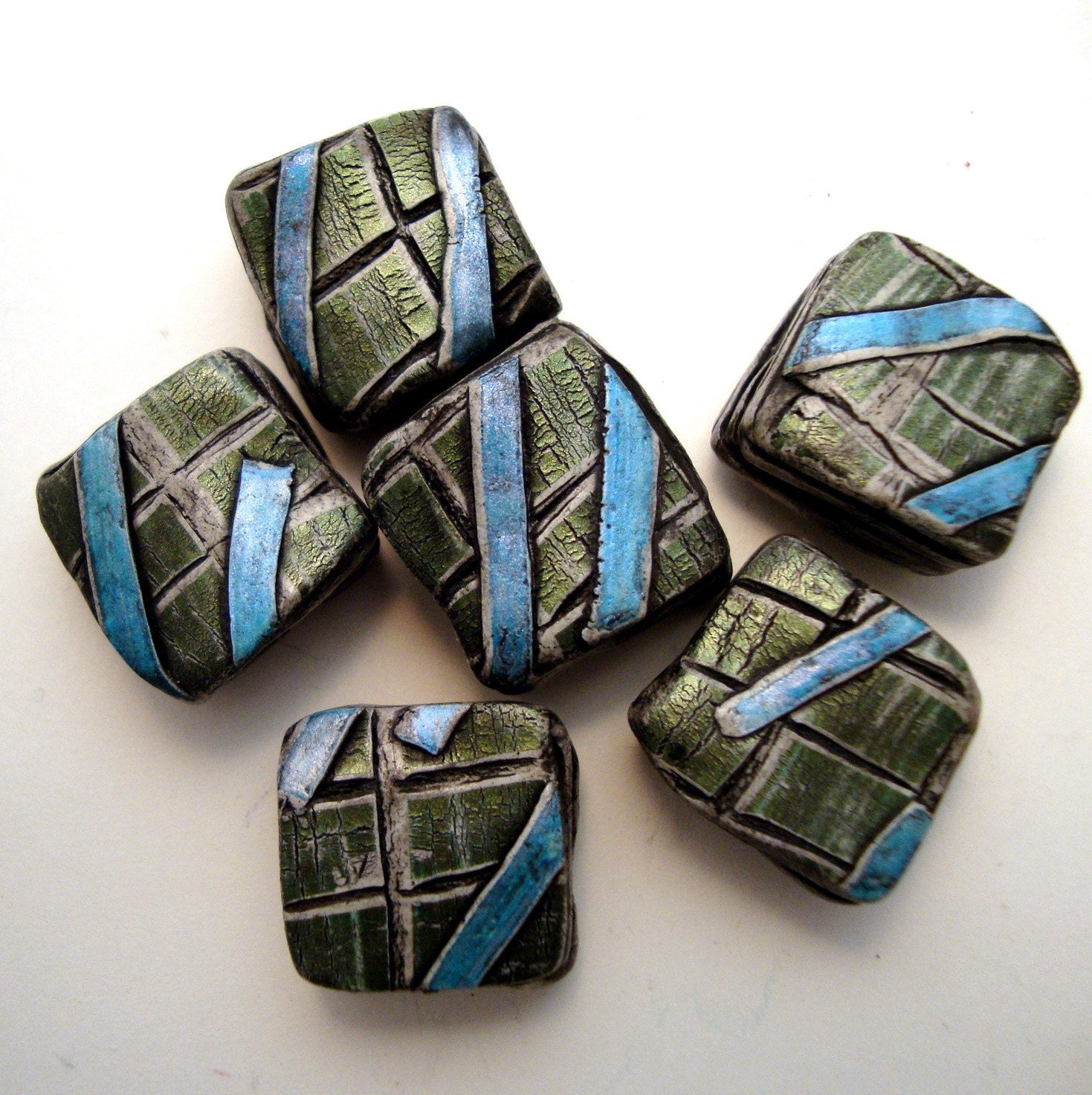 Altered cube strata beads with green mosaic and cerulean bands in polymer