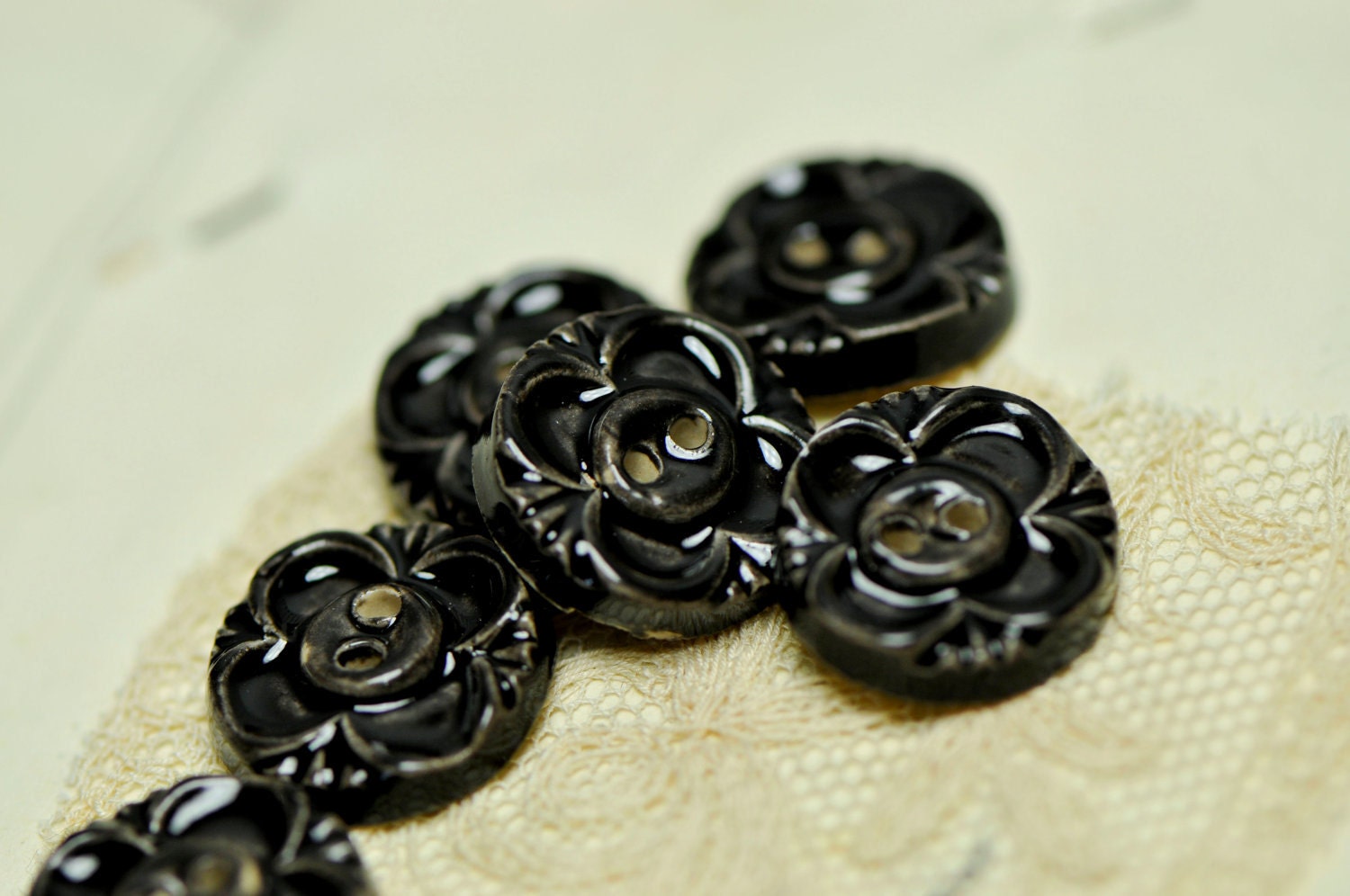 6 black .sew on buttons