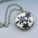 Silver framed polymer clay pendant necklace on oxidized sterling silver chain