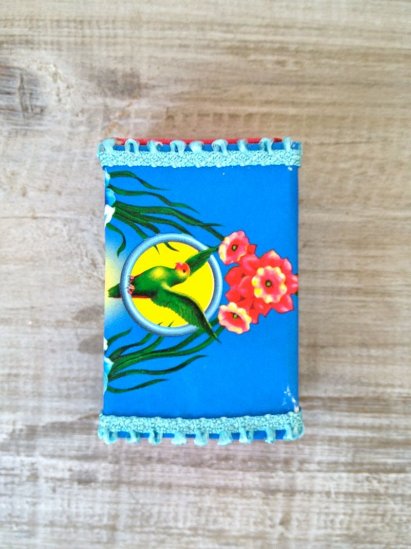 Altered vintage matchbox with a tropical bright greeting inside