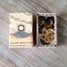 Altered vintage matchbox with a sparkling nature scene inside