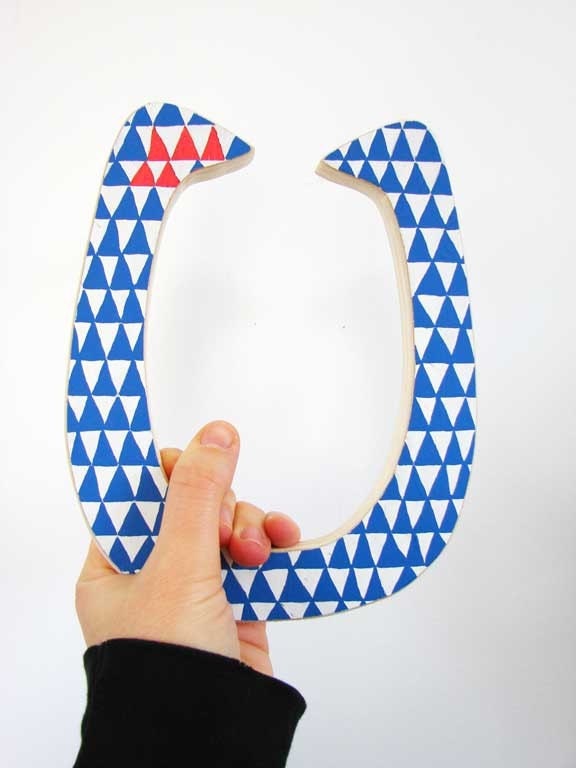 Lucky wooden horseshoe with geometric pattern