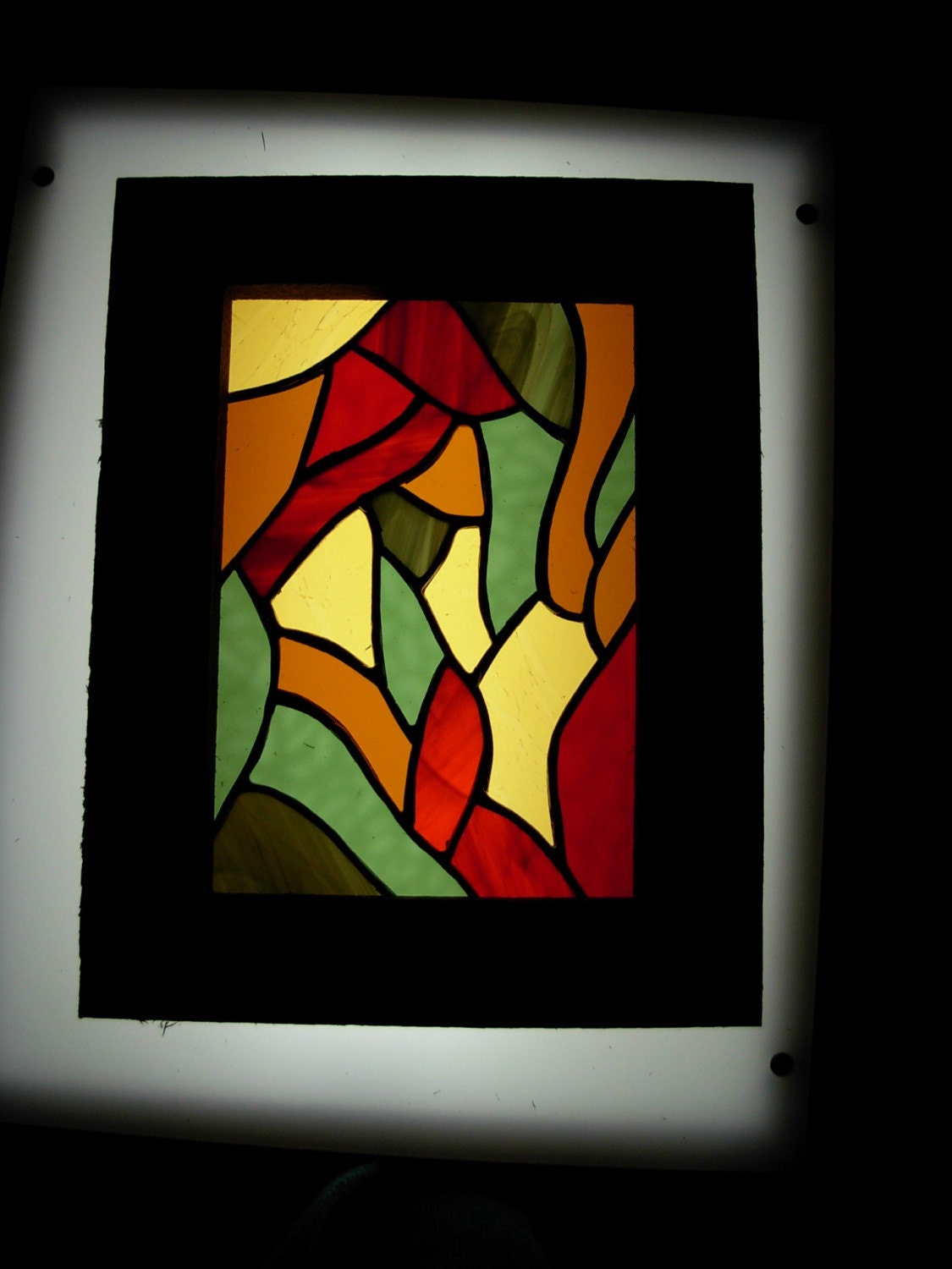 Swirling in from the outside a stained glass panel