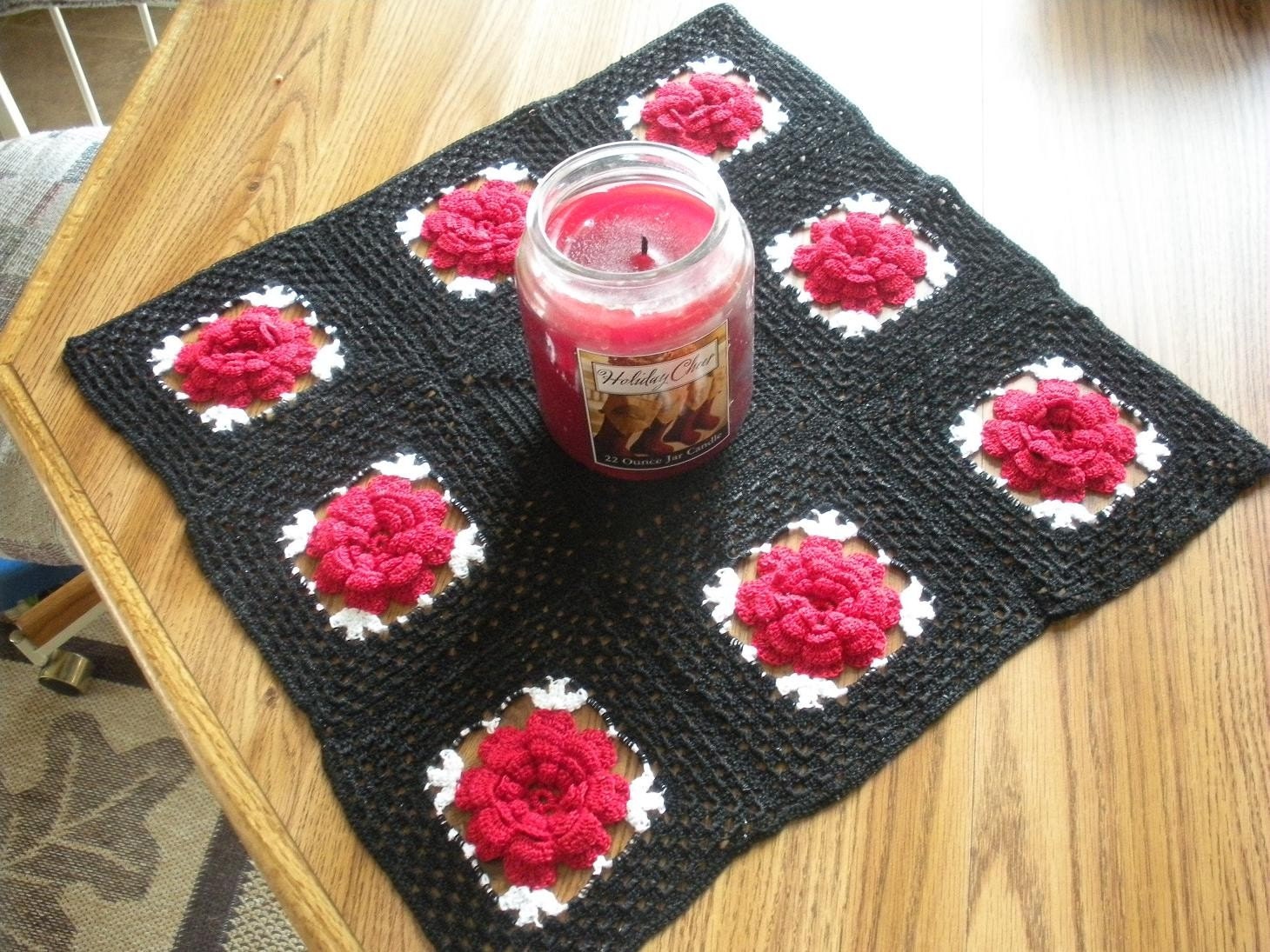 red rose on black table runner