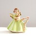 Josef Angel Birthday Girl Year 7 Holding Baby Doll Lime Green Dress Gold Accents Black Eyes Original Tags