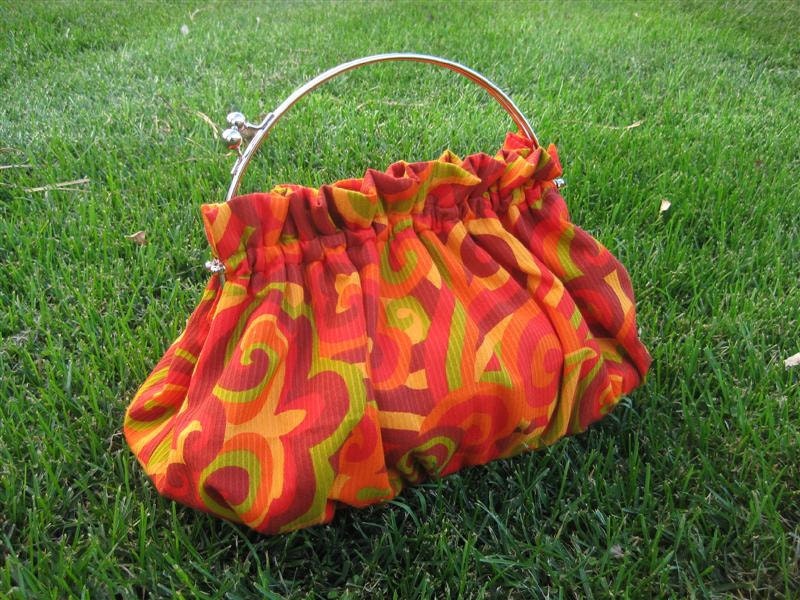 Purse in Swirls of Orange Red Yellow and Green with 10 Inch Frame