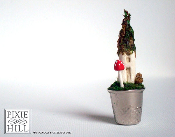 Fairy cottage and toadstool on a mossy thimble lawn - A Faerie Garden