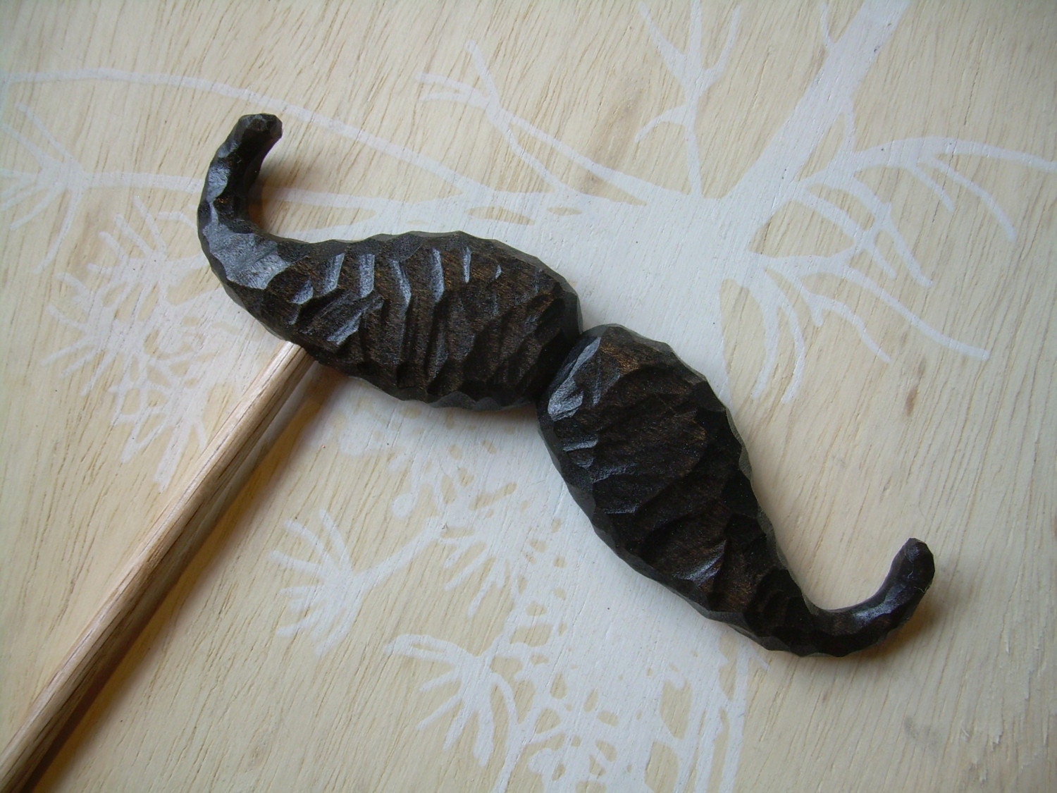 mustache on a stick