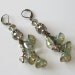 Long earrings, lucite flowers, iridescent light olive green with crystals and antique brass