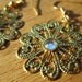 Brass Circle Flower Chandelier Earrings with Rhinestone Like Center