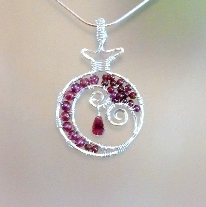 Open Pomegranate II (Rimon)  sterling silver and garnet pendant. 