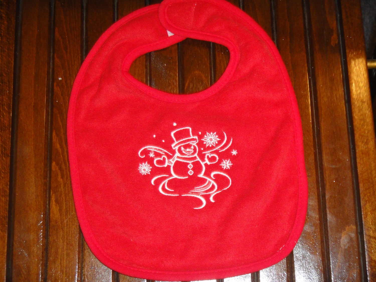 Snowman and swirling snowflake bib