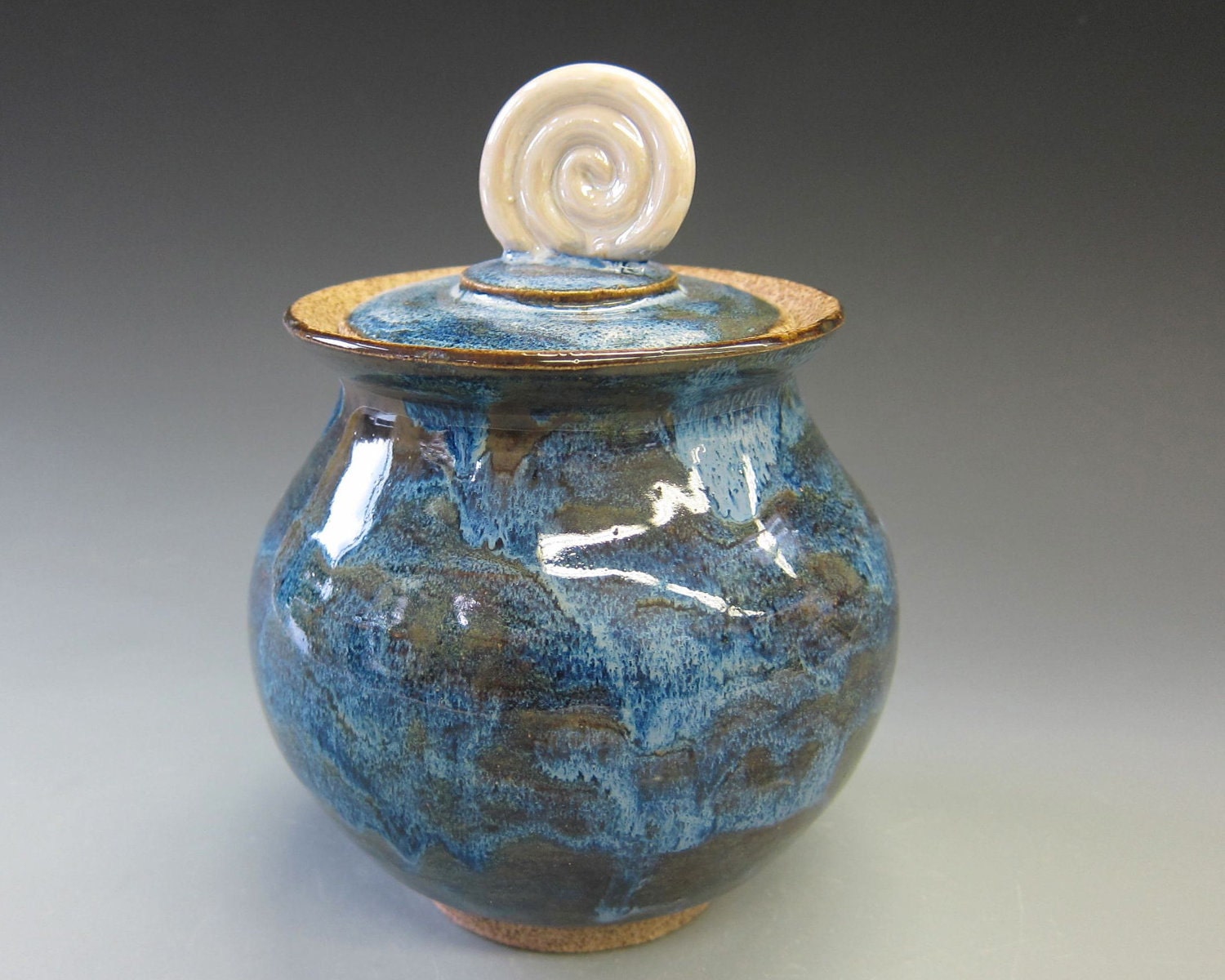 Iridescent spiral top on a wheelthrown pot/stoneware
