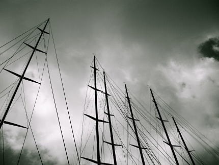 Masts: dramatic black and white fine art photograph print of a row of sailboat masts and lines against gray, cloudy sky - UninventedColors