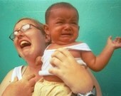 Apparent Anguish: a funny and melodramatic fine art portrait photograph print of a baby crying and a woman humorously mocking her