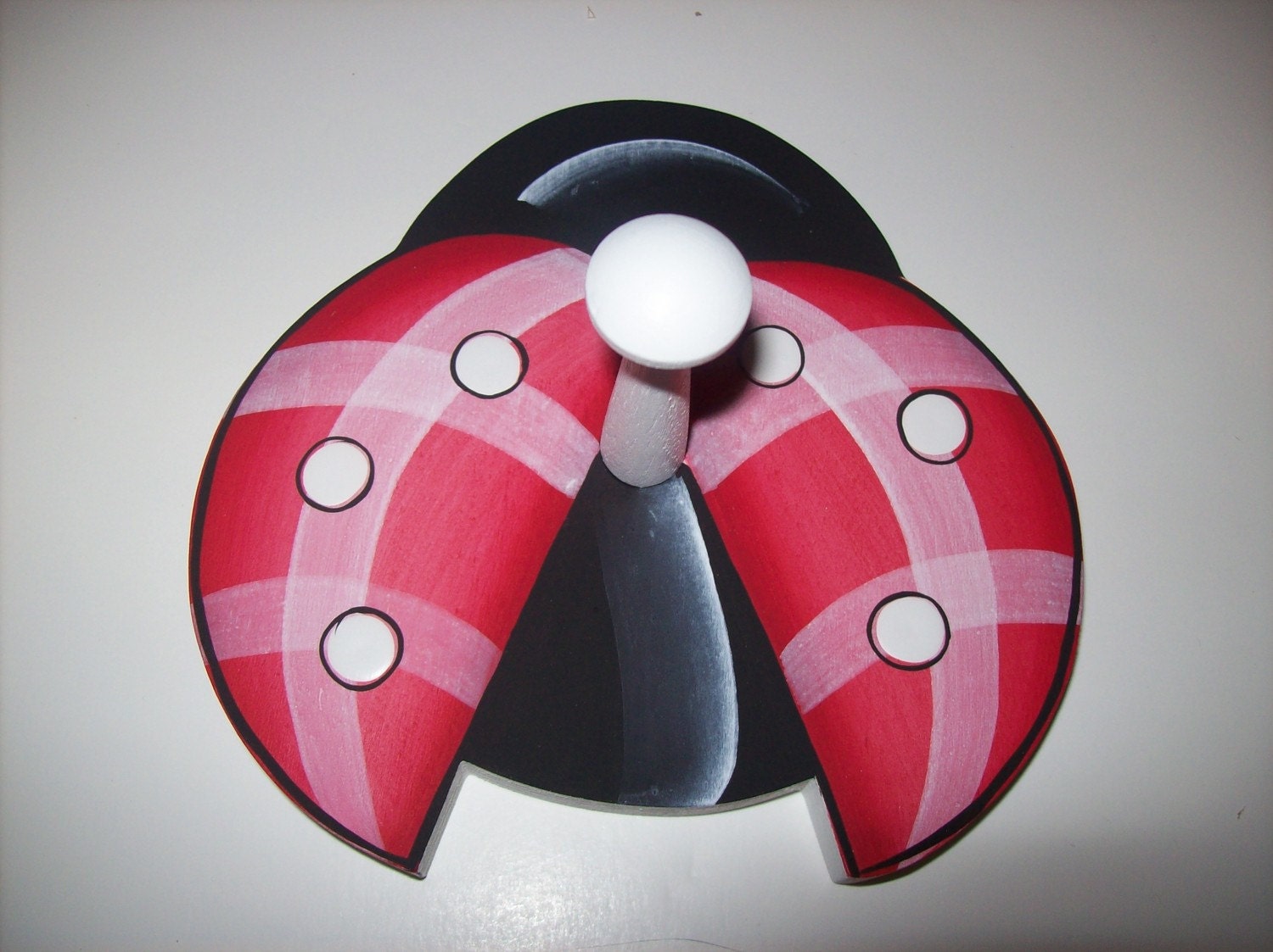 Handpainted childrens coat peg , towel rack or hat rack in black and red lady bug design