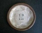 brown plate with CUTLERY.