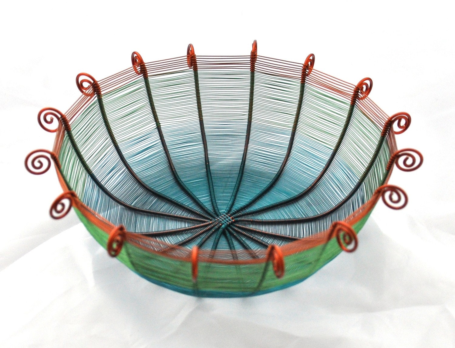 Sixteen sided copper wire basket in teal blue, green, and brown