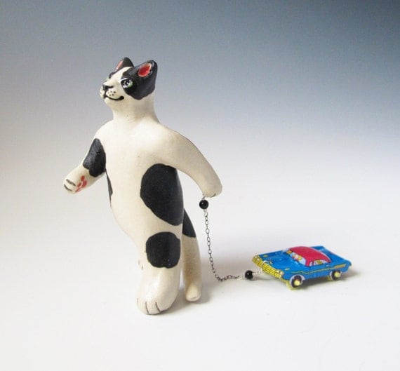 Cat pulling a toy car - hand sculpted ceramic figurine