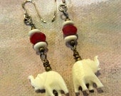Earrings with ruby red beads and carved elephants