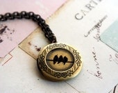 birds on a wire. locket necklace. black and brass ox