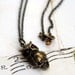 owl eyes. pendant necklace. antiqued brass