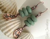 Antiqued copper earrings featuring teardrop charms with flower imprint and polymer clay pebbles