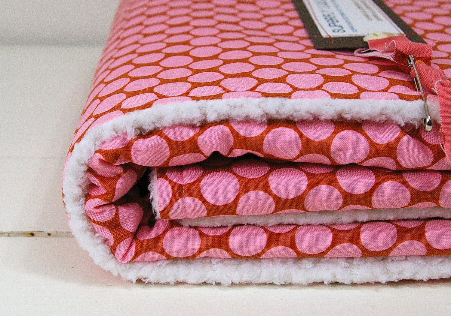 baby blanket, pink polkadot on brown, classic and modern, parent-friendly.
