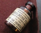 Reproduction vintage Egyptian Chemical Company Embalming Fluid miniature glass bottle charm
