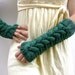 Long fingerless gloves , mittens  in green with a cable pattern