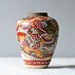brown pottery vase / asian figures / brown white dots