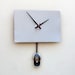 Clock created from a recycled Apple Powerbook laptop cover