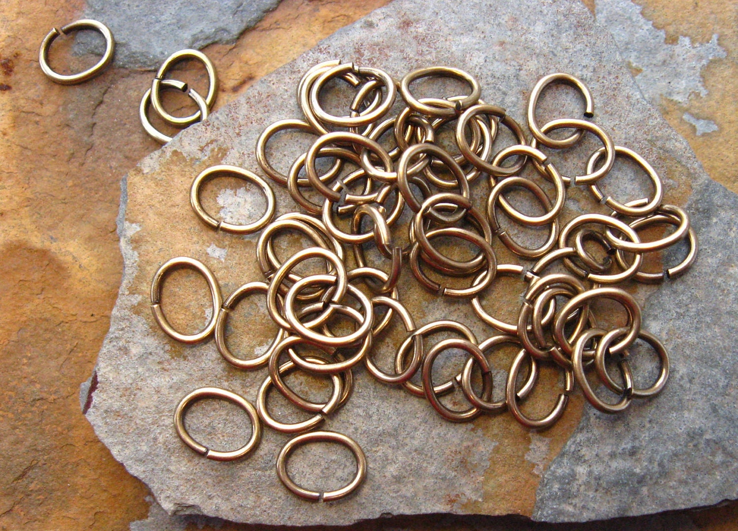 50 Antique Gold Patina 7mm  x 5mm Oval 20 Gauge Jumprings -  Trinity Brass Co. LOW SHIPPING