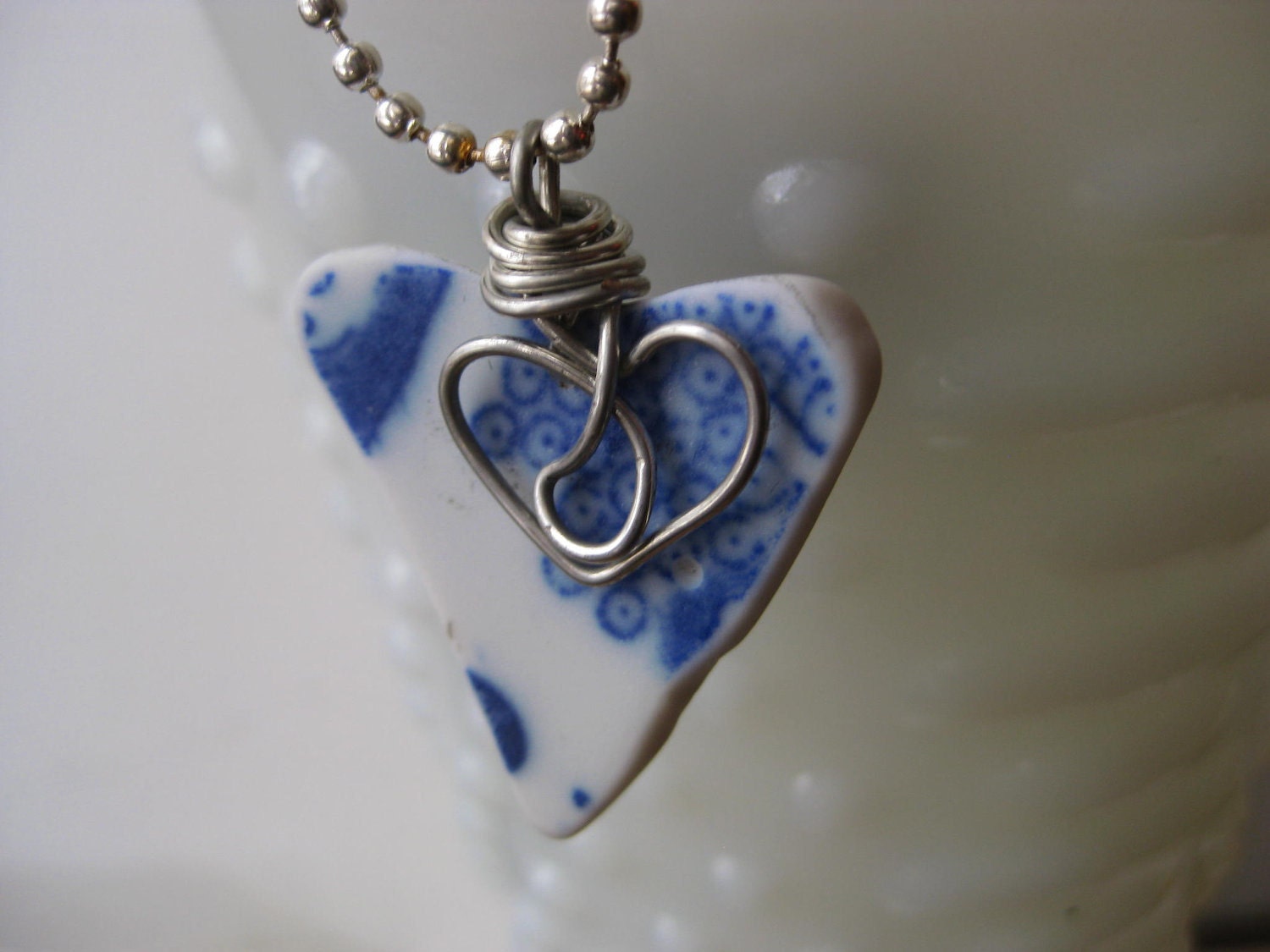 seaglass inspired Heart of Blue tumbled wire wrapped pottery pendant