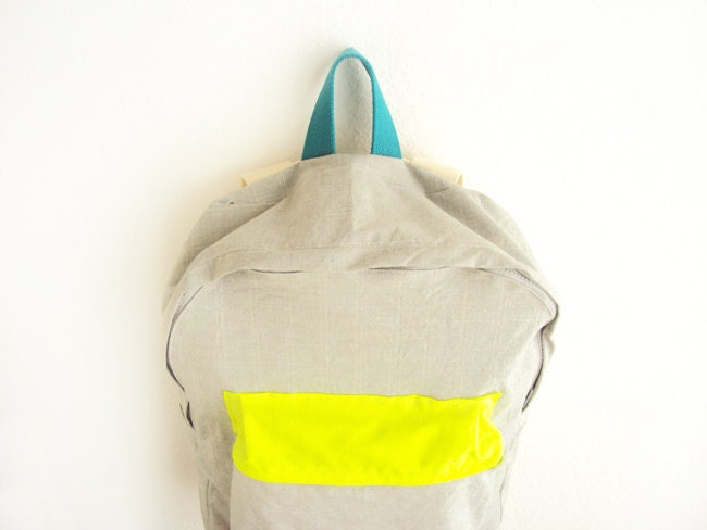 Light grey with thin stripes backpack with neon yellow pouch