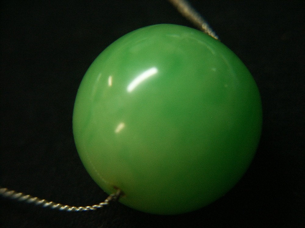 Necklace with silver metal chain and one large round swirled light grass green genuine tested bakelite plastic bead