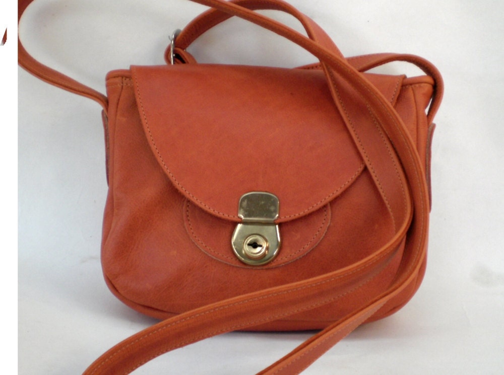 small burnt orange shoulder bag with hand stitching