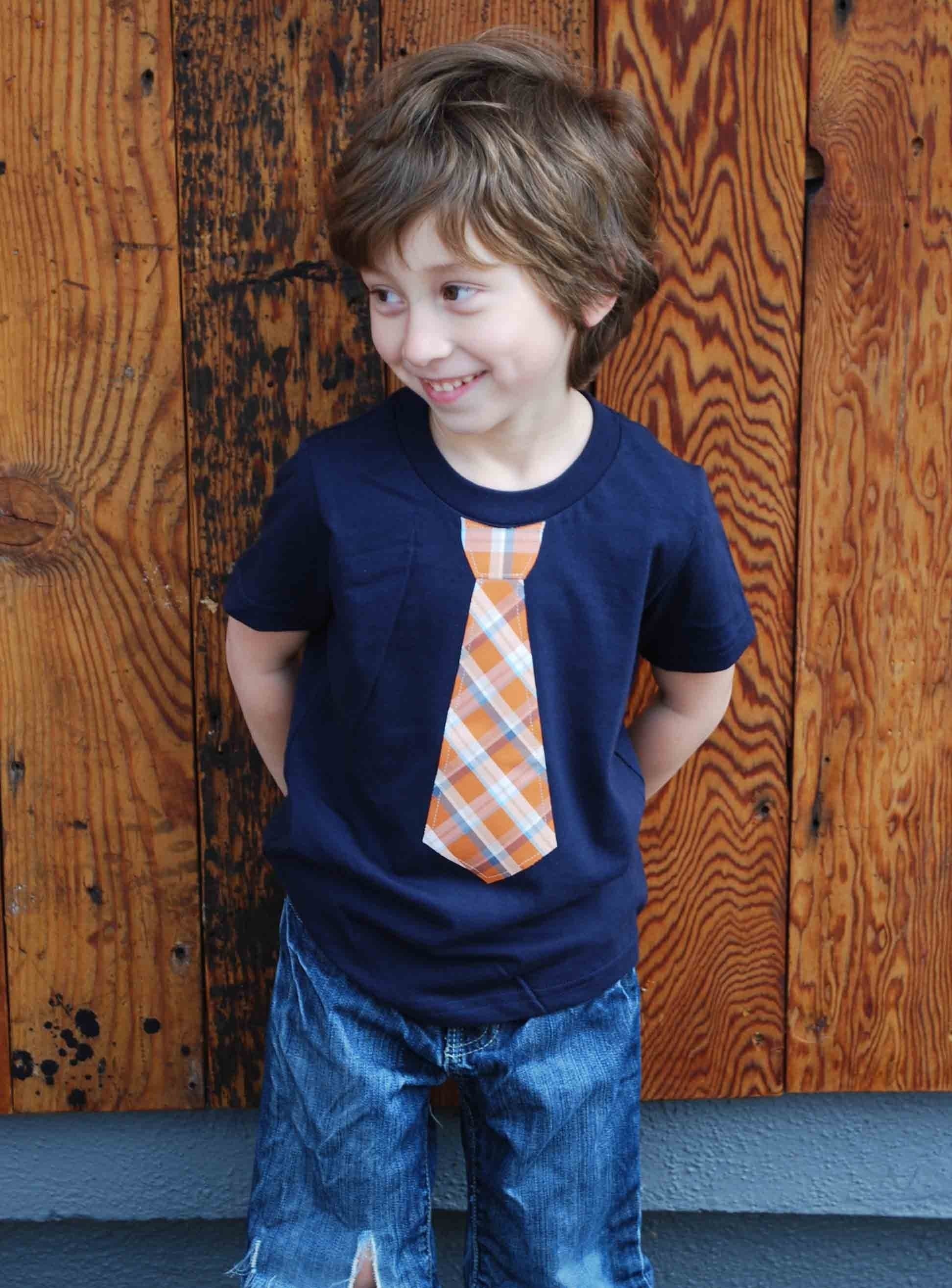 2T........NAVY fine Jersey T-shirt with an ORANGE PLAID neck tie applique ........... COMFORTABLE AND TRENDY