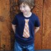 2T........NAVY fine Jersey T-shirt with an ORANGE PLAID neck tie applique ........... COMFORTABLE AND TRENDY