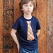 2T........NAVY fine Jersey T-shirt with an ORANGE PLAID neck tie applique ........... COMFORTABLE AND TRENDY