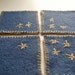 Set of 4 felted blue coasters, made from upcycled wool sweater, hand embroidered in beige with primitive stars design